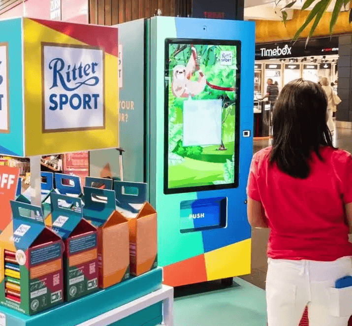 Woman using a Ritter Sport vending machine